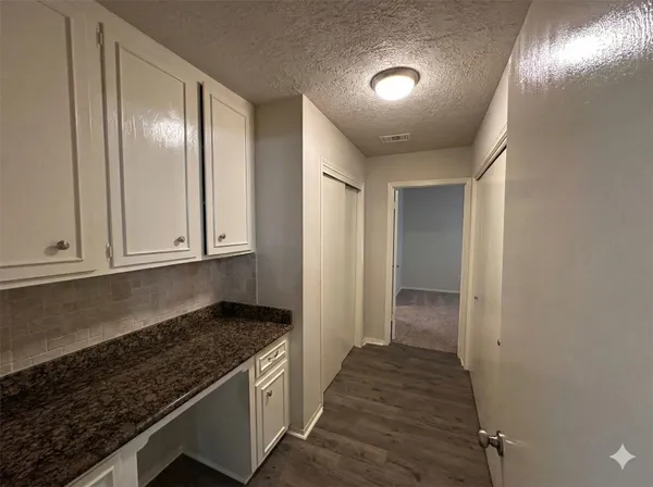 a view of an empty room and wooden floor