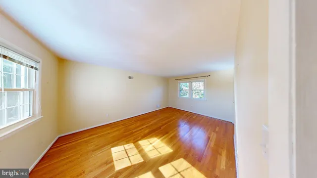 a bathroom with a granite countertop sink a toilet a shower curtain and a large mirror