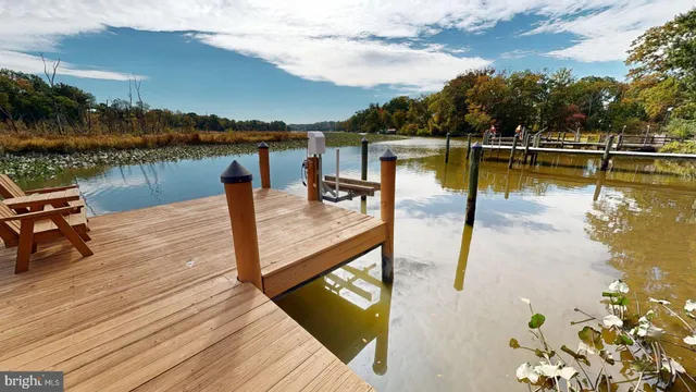 a view of a lake with couches chairs on the roof deck