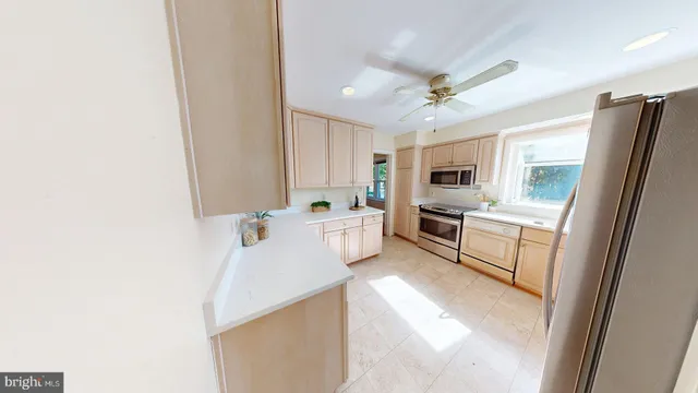 a large white kitchen with cabinets