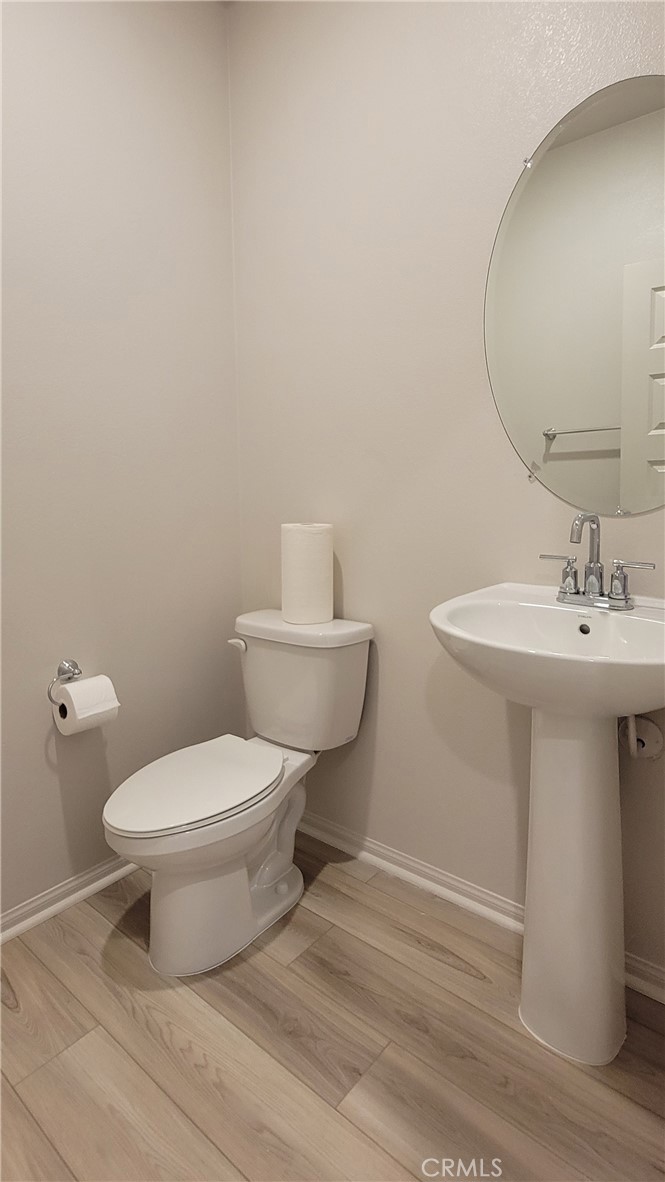 32916 Earlsburn Circle Menifee, CA 92584 - Photo 11 of 34 a bathroom with a sink toilet and a mirror