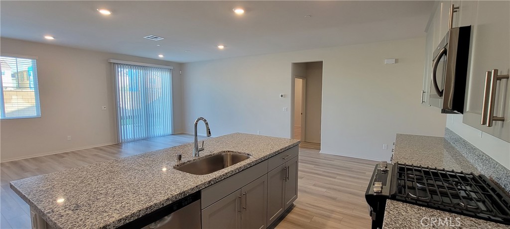 32916 Earlsburn Circle Menifee, CA 92584 - Photo 15 of 34 a kitchen with stainless steel appliances granite countertop a sink and a refrigerator