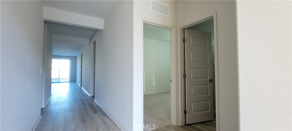 32916 Earlsburn Circle Menifee, CA 92584 - Photo 4 of 34 a view of a hallway with wooden floor