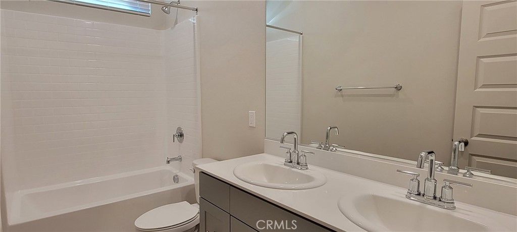 32916 Earlsburn Circle Menifee, CA 92584 - Photo 6 of 34 a bathroom with a sink and a mirror