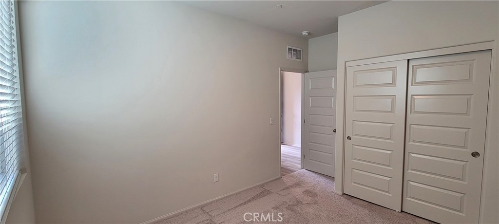 32916 Earlsburn Circle Menifee, CA 92584 - Photo 7 of 34 a view of walk in closet with empty racks