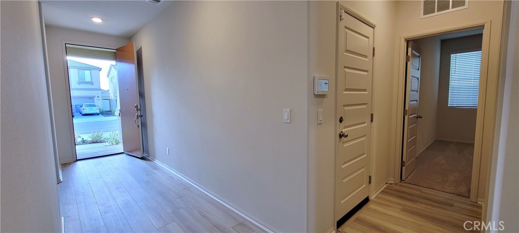 32916 Earlsburn Circle Menifee, CA 92584 - Photo 8 of 34 a view of a hallway with wooden floor