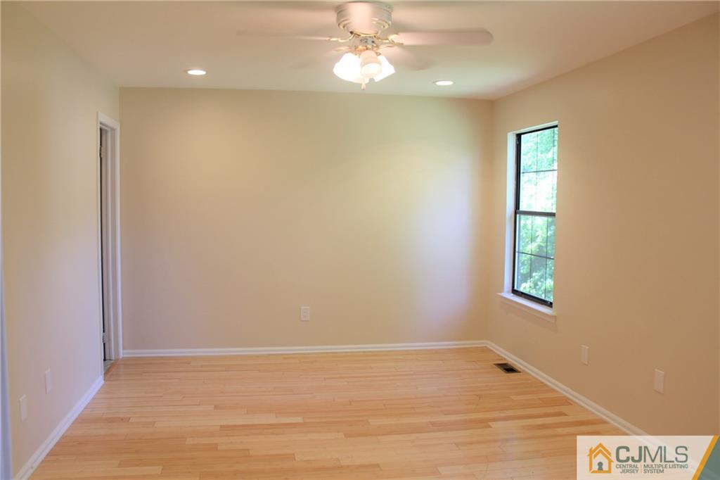 903 Timber Oaks Road, Unit 903 Edison, NJ 08820 - Photo 17 of 34 an empty room with windows and fan