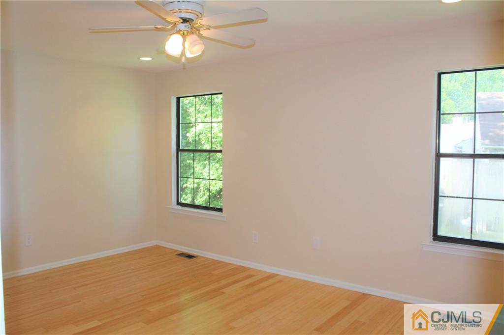 903 Timber Oaks Road, Unit 903 Edison, NJ 08820 - Photo 18 of 34 an empty room with windows and fan