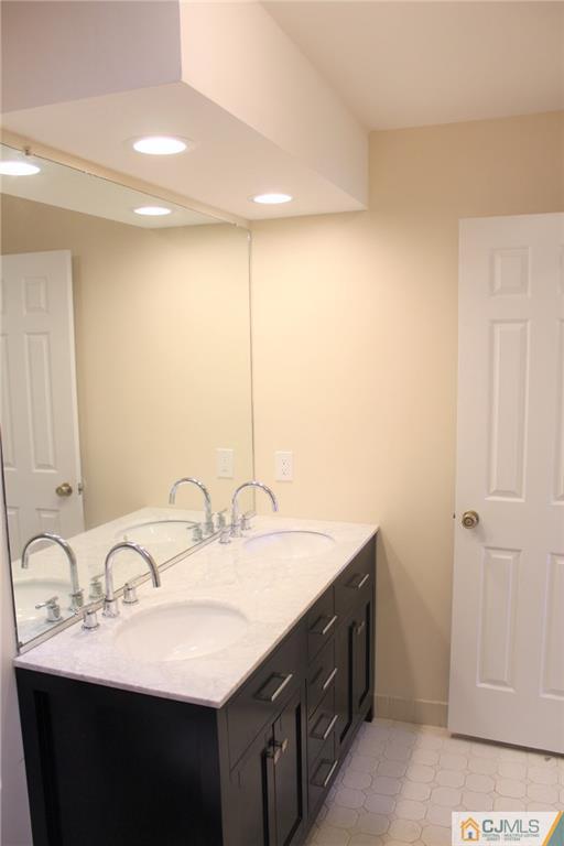 903 Timber Oaks Road, Unit 903 Edison, NJ 08820 - Photo 21 of 34 a bathroom with a double vanity sink and a mirror
