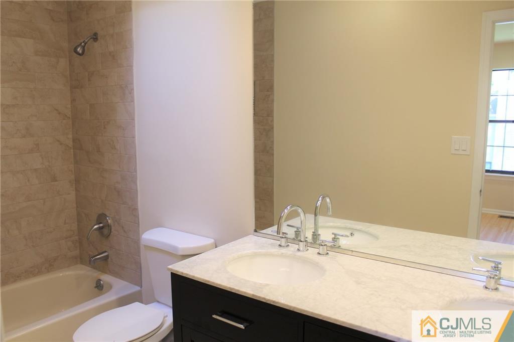 903 Timber Oaks Road, Unit 903 Edison, NJ 08820 - Photo 22 of 34 a bathroom with a sink and a mirror