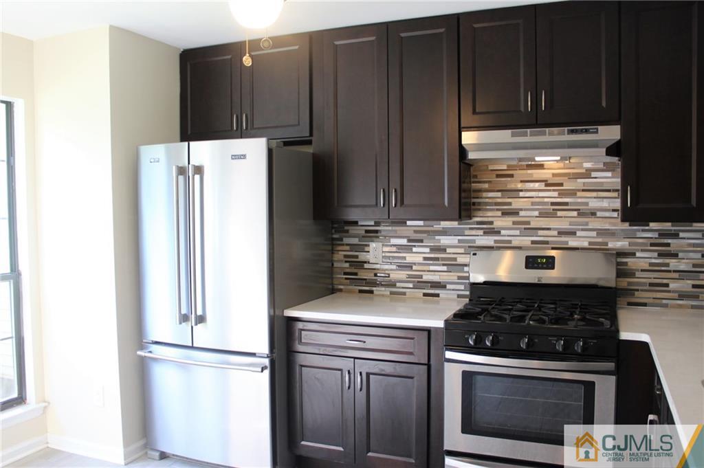 903 Timber Oaks Road, Unit 903 Edison, NJ 08820 - Photo 4 of 34 a kitchen with refrigerator and cabinets