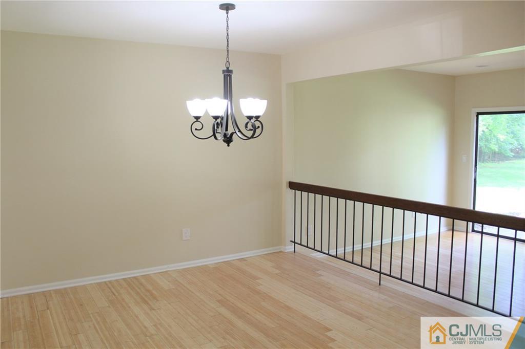 903 Timber Oaks Road, Unit 903 Edison, NJ 08820 - Photo 8 of 34 a view of a room with a chandelier fan and wooden floor