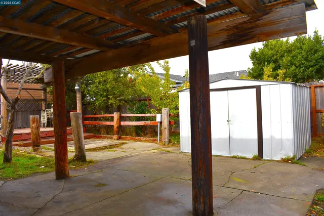 a view of porch with a table and chairs next to a yard