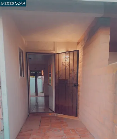 a view of a hallway with wooden shelves