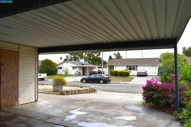 a view of a porch with furniture and garden