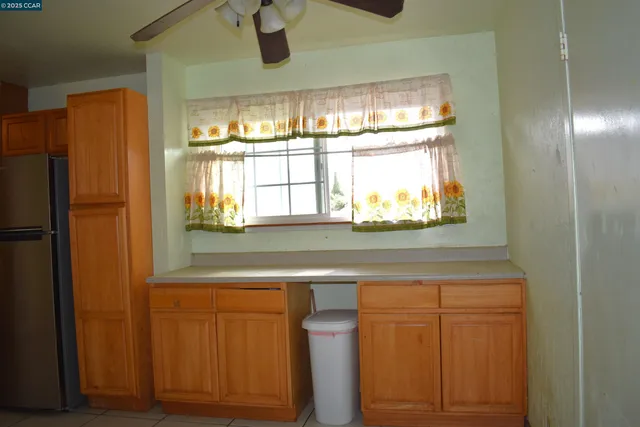 a kitchen with stainless steel appliances granite countertop a refrigerator and window