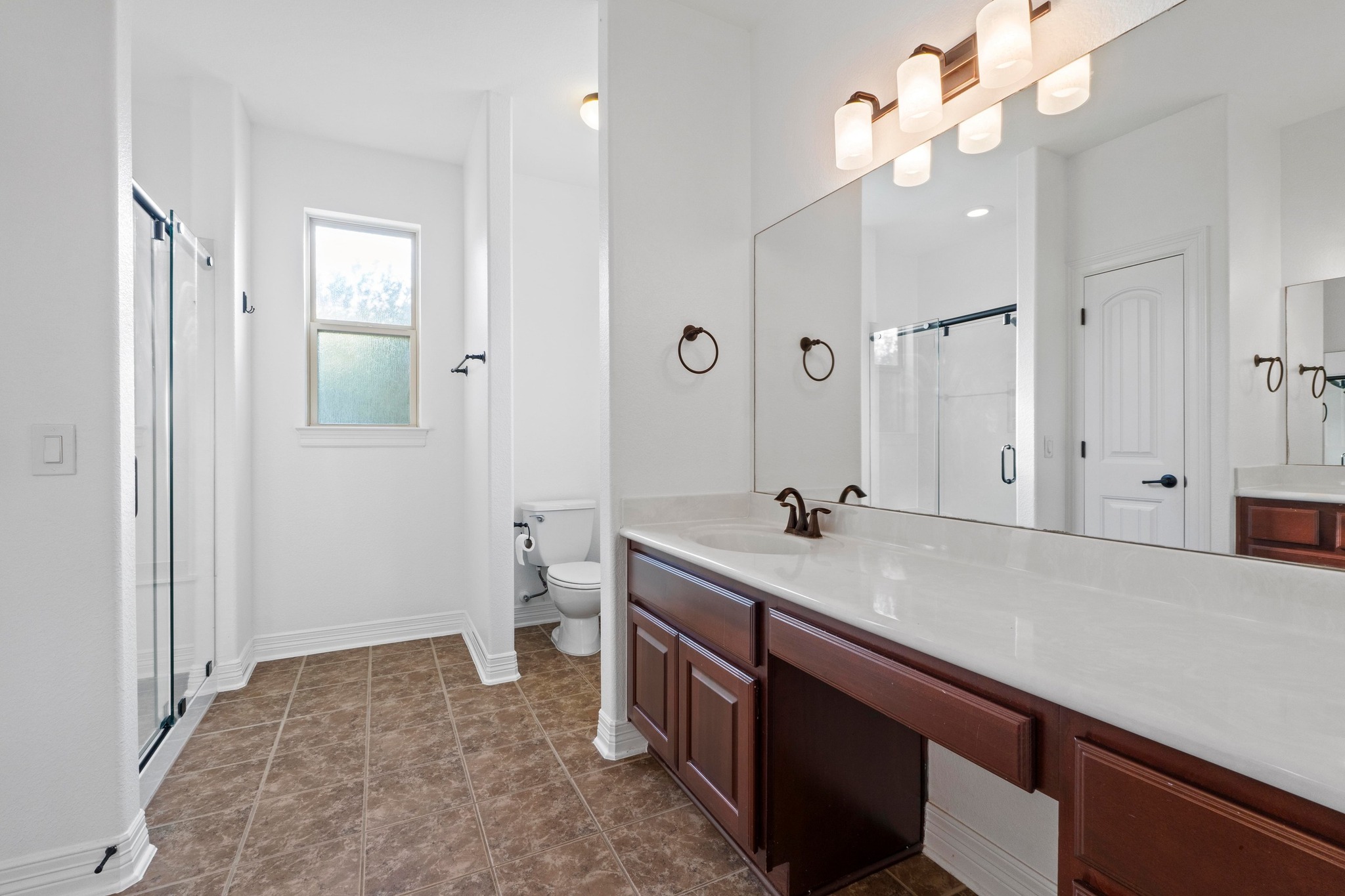 4129 Lawless Street Austin, TX 78723 - Photo 17 of 38 a bathroom with a sink a toilet and a mirror