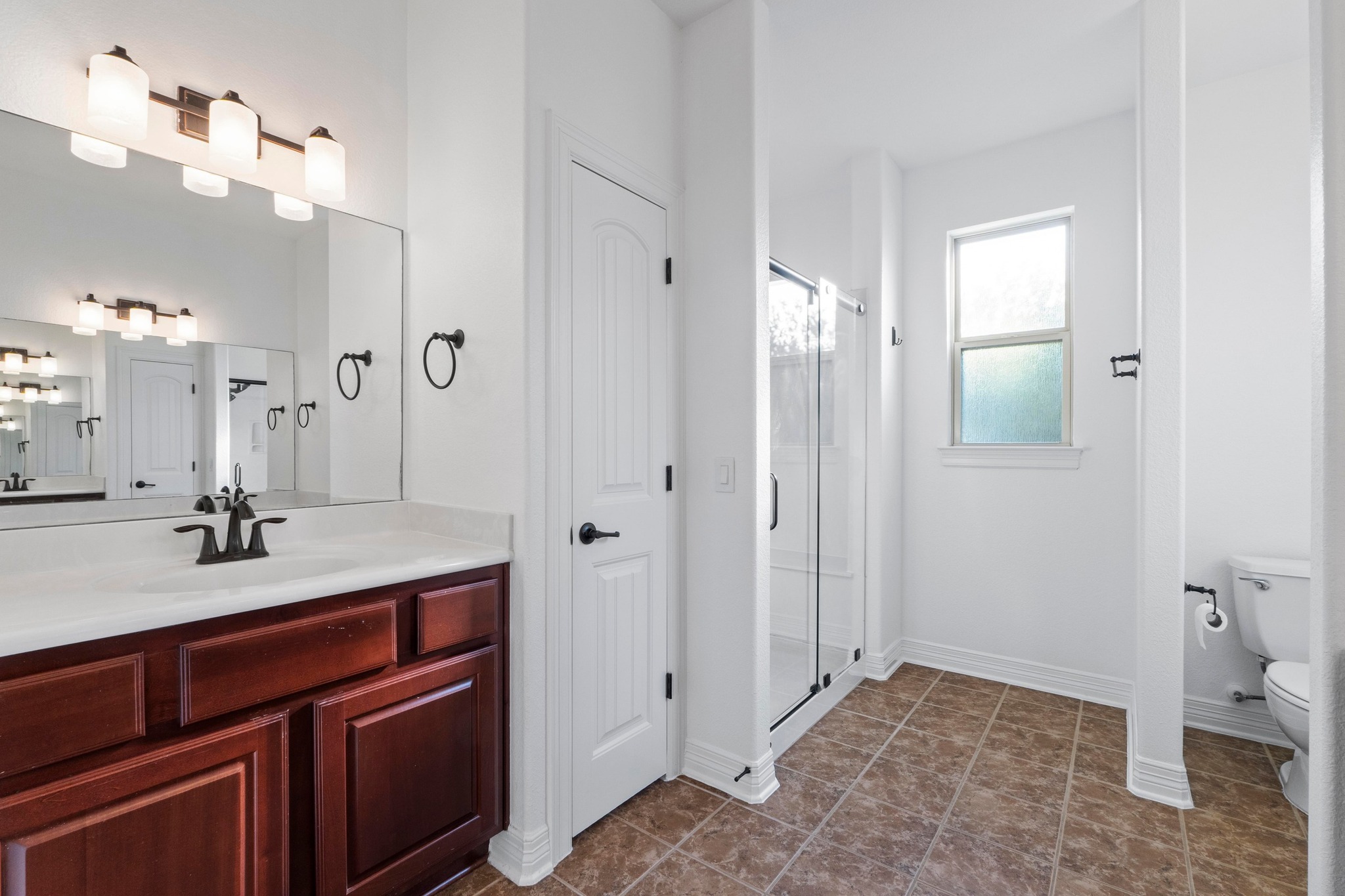 4129 Lawless Street Austin, TX 78723 - Photo 18 of 38 a bathroom with a sink a toilet and shower