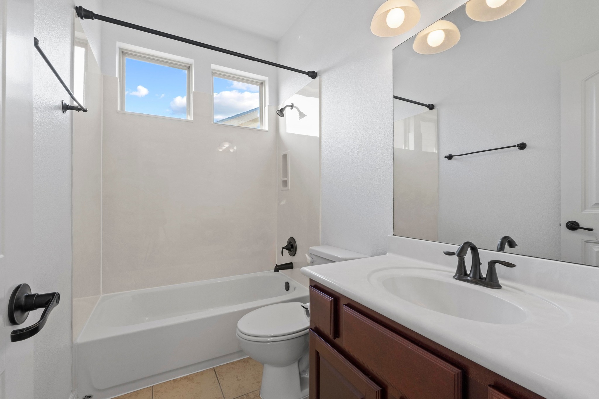 4129 Lawless Street Austin, TX 78723 - Photo 34 of 38 a bathroom with a sink a toilet and shower