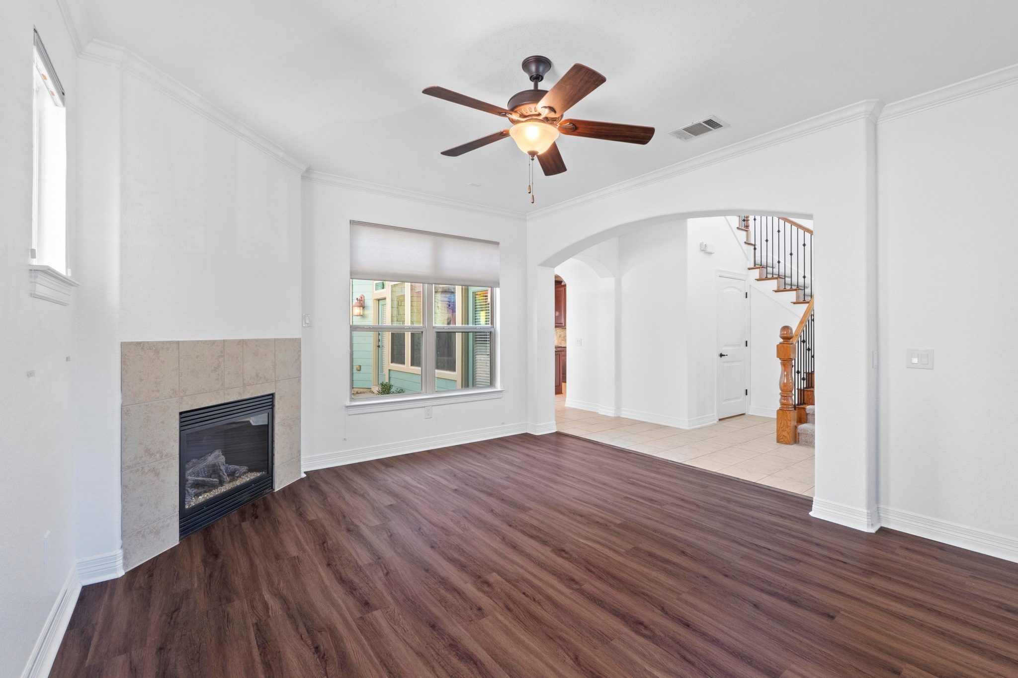 4129 Lawless Street Austin, TX 78723 - Photo 4 of 38 a view of an empty room with wooden floor and a fireplace