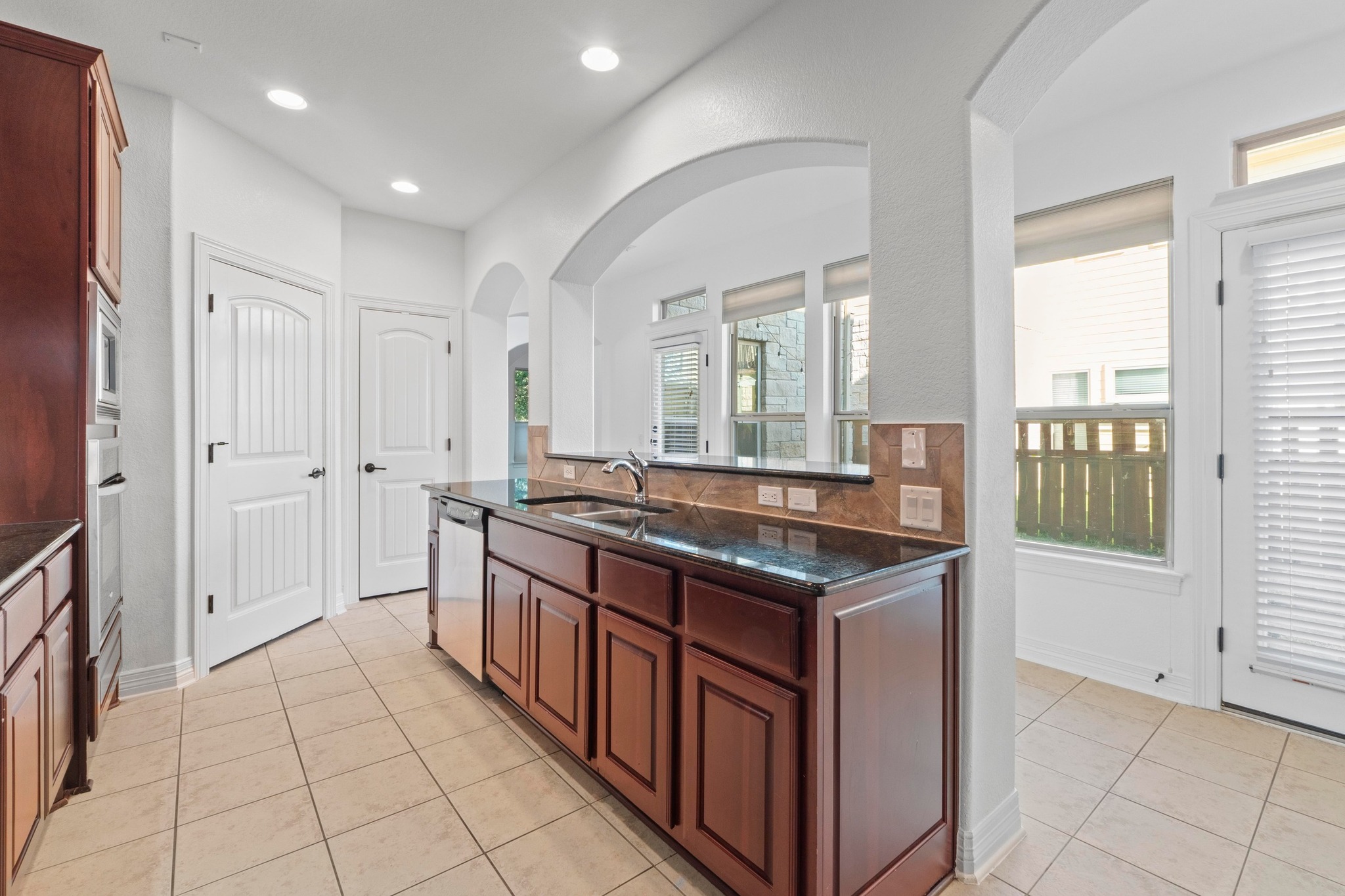 4129 Lawless Street Austin, TX 78723 - Photo 10 of 38 a kitchen with stainless steel appliances granite countertop a stove and a sink