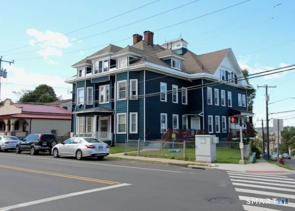 a car parked in front of a white building