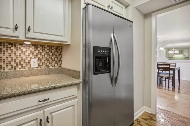 a view of a kitchen cabinets and refrigerator