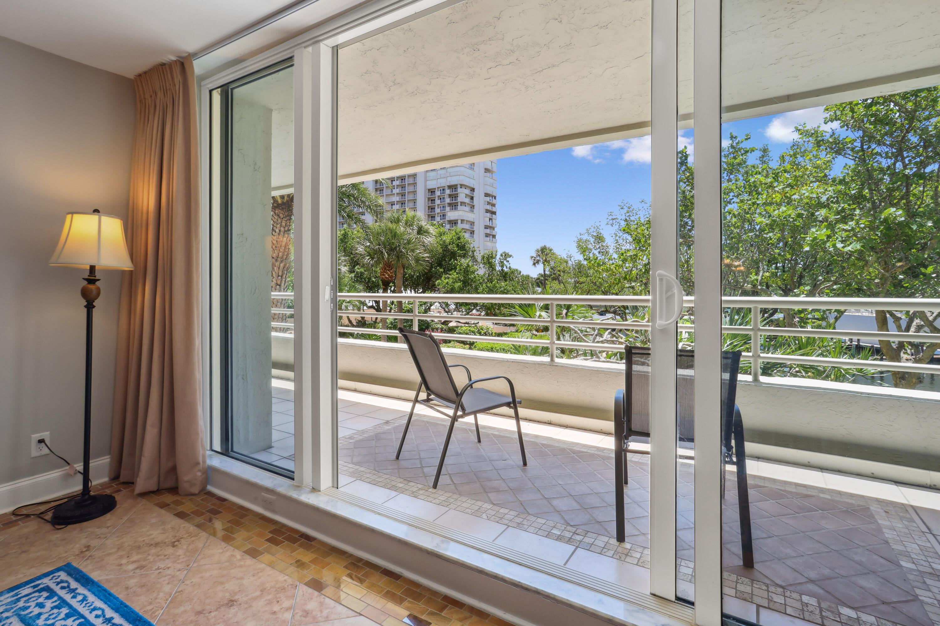 4201 North Ocean Boulevard, Unit 208 Boca Raton, FL 33431 - Photo 12 of 38 a view of a room with a large window and wooden floor
