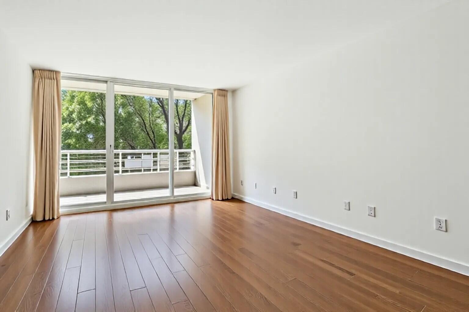 4201 North Ocean Boulevard, Unit 208 Boca Raton, FL 33431 - Photo 14 of 38 wooden floor in an empty room with a window