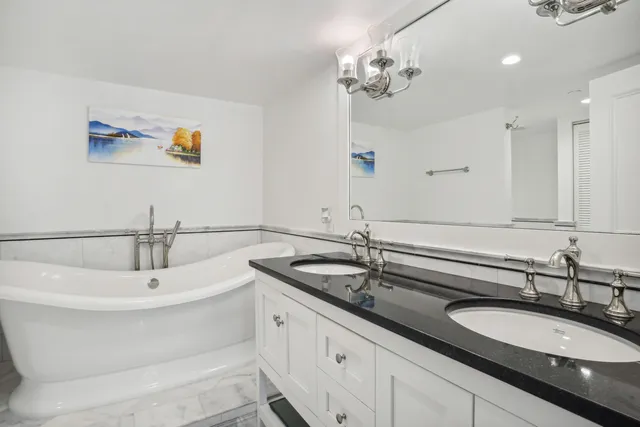 a bathroom with a double vanity sink and a mirror