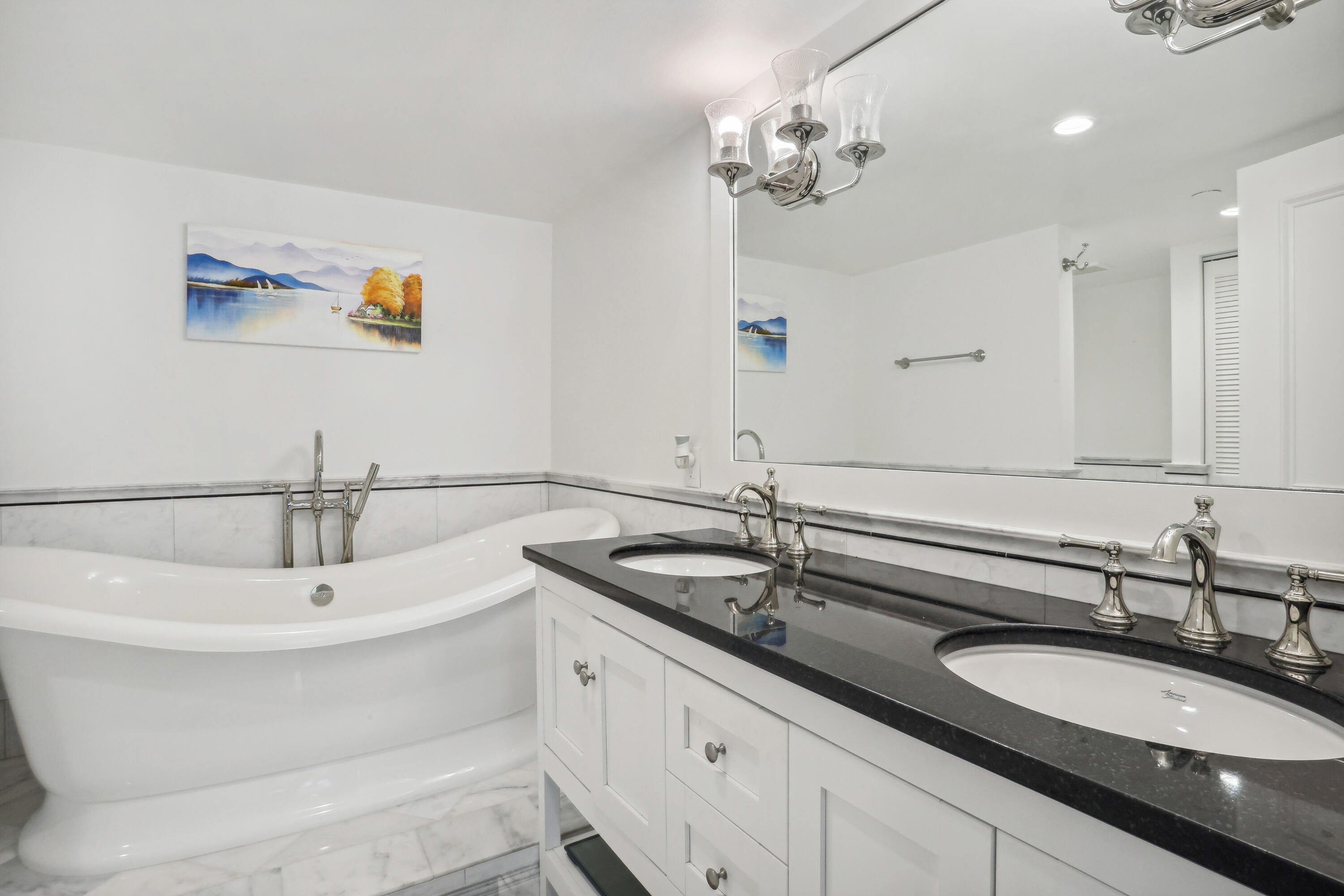 4201 North Ocean Boulevard, Unit 208 Boca Raton, FL 33431 - Photo 16 of 38 a bathroom with a double vanity sink and a mirror