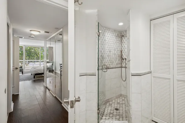 a bathroom with a glass door shower and a sink