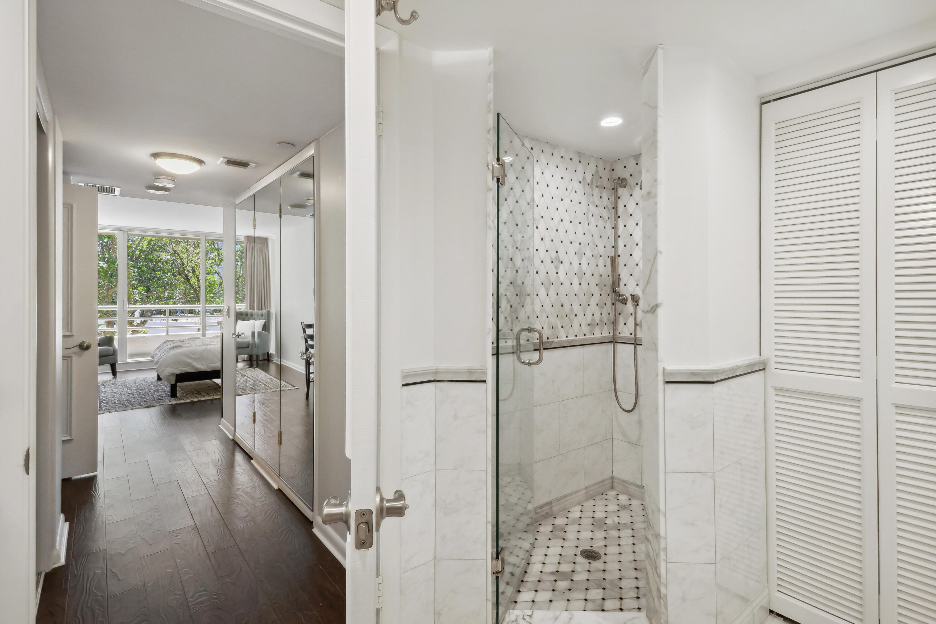 4201 North Ocean Boulevard, Unit 208 Boca Raton, FL 33431 - Photo 17 of 38 a bathroom with a glass door shower and a sink