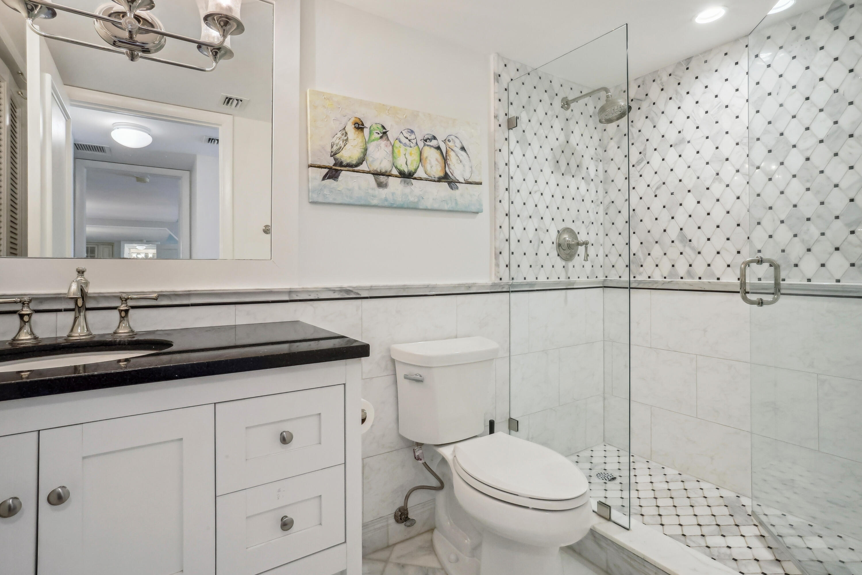 4201 North Ocean Boulevard, Unit 208 Boca Raton, FL 33431 - Photo 20 of 38 a bathroom with a granite countertop sink a toilet and a mirror