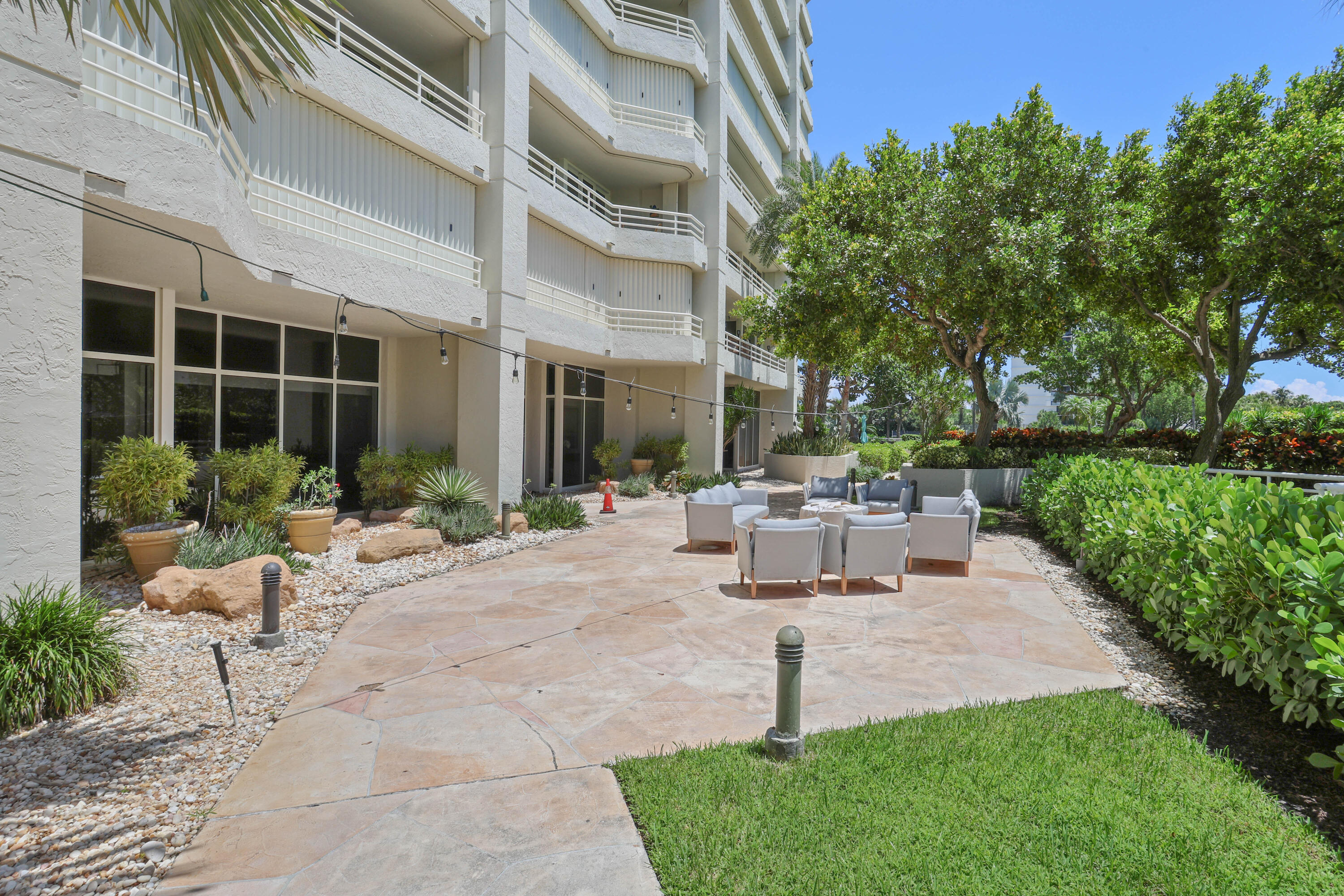 4201 North Ocean Boulevard, Unit 208 Boca Raton, FL 33431 - Photo 25 of 38 a view of a house with backyard sitting area and garden