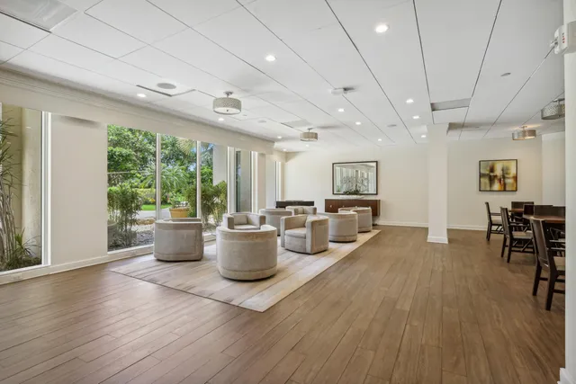 a very nice looking living room with a large window and wooden floor