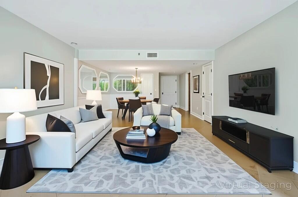 4201 North Ocean Boulevard, Unit 208 Boca Raton, FL 33431 - Photo 5 of 38 a living room with furniture and a flat screen tv