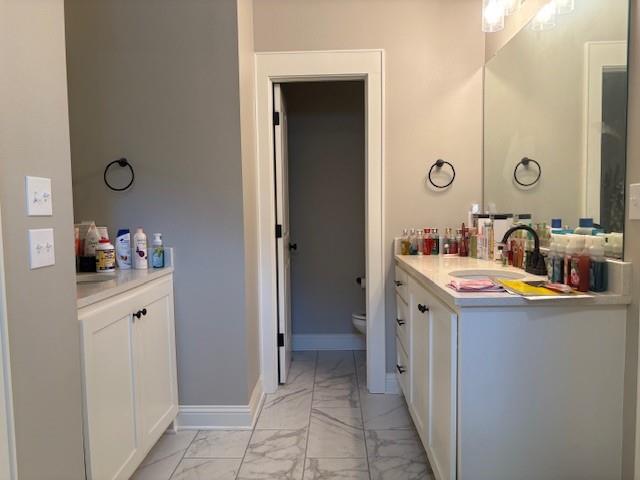 6896 Bethany Reed Circle Blanchard, LA 71107 - Photo 5 of 9 Bathroom featuring a double vanity with white cabinetry, light-toned countertops, and dual mirrors