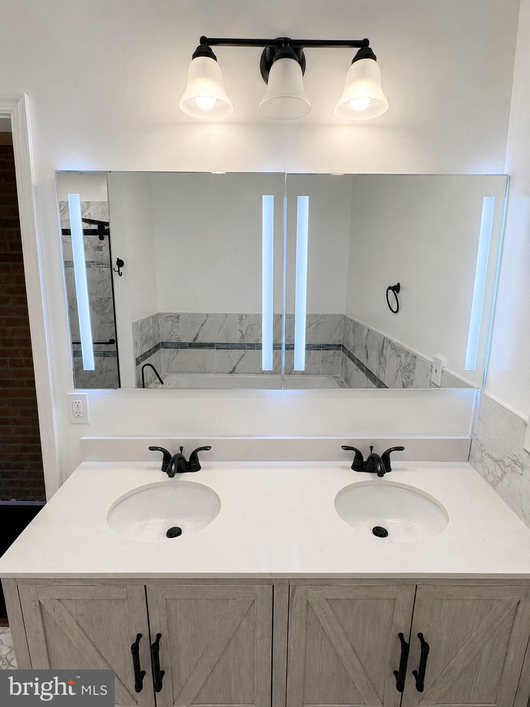 1610 Federal Street Baltimore, MD 21213 - Photo 14 of 27 Sleek dual vanity with modern lighting.