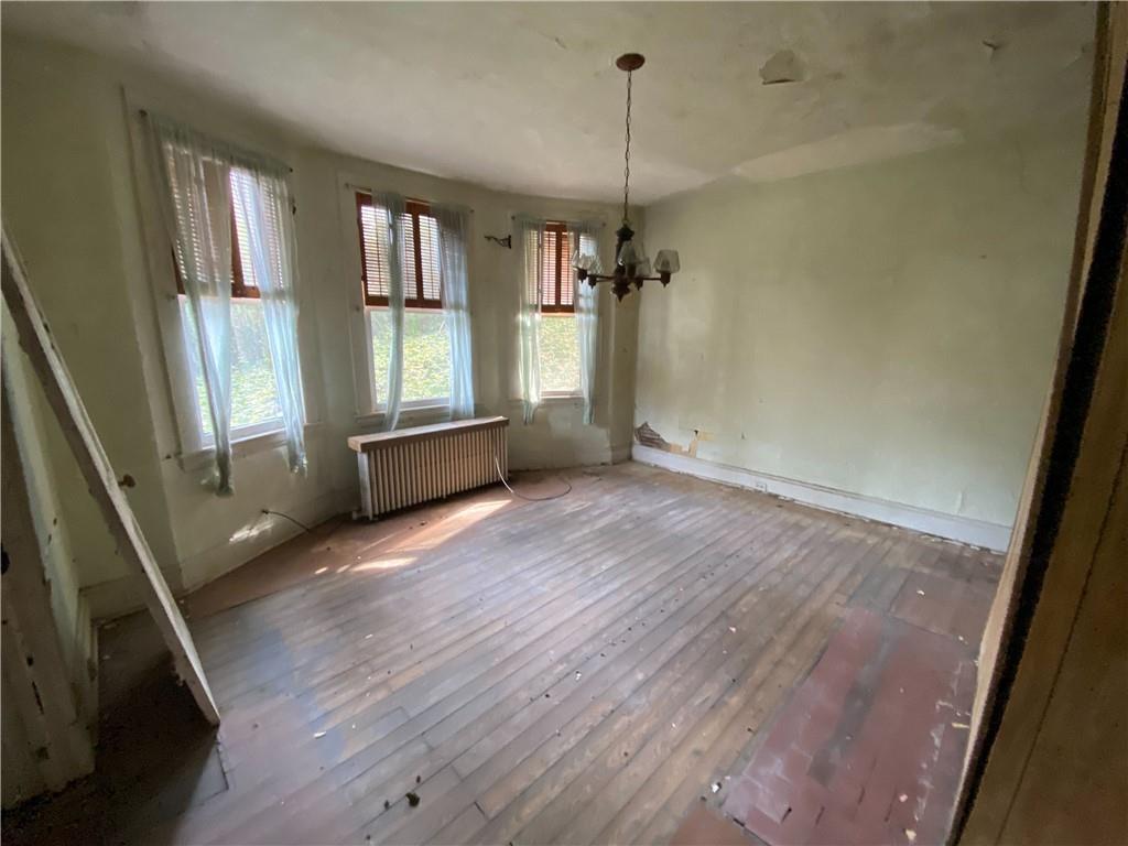419 Maytide Street Pittsburgh, PA 15227 - Photo 8 of 28 a view of empty room with wooden floor and fan