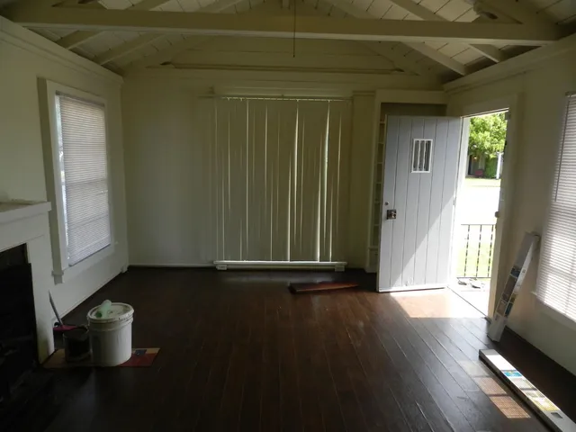 a view of a room that has wooden floor and chair