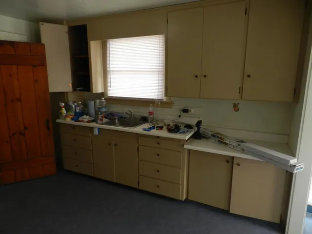 a room with window and cabinets