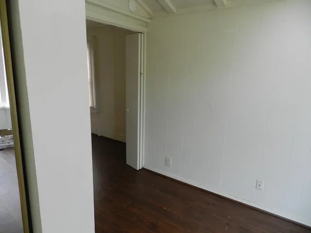 a view of a small space with wooden floor