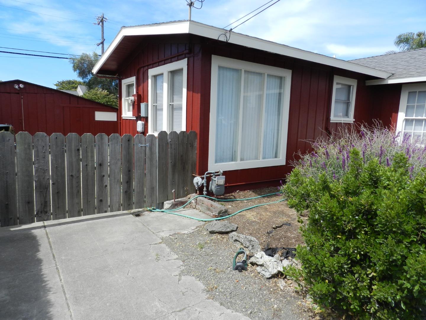 50 Katherine Avenue Salinas, CA 93901 - Photo 22 of 30 a backyard of a house with table and chairs under an umbrella