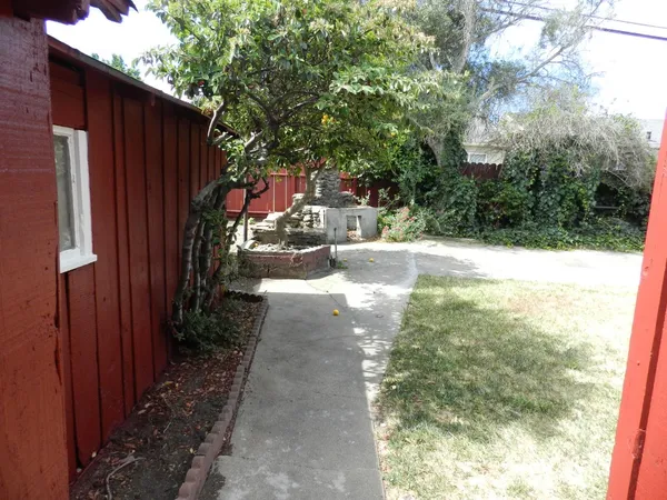 a view of a pathway of a house with backyard of the house
