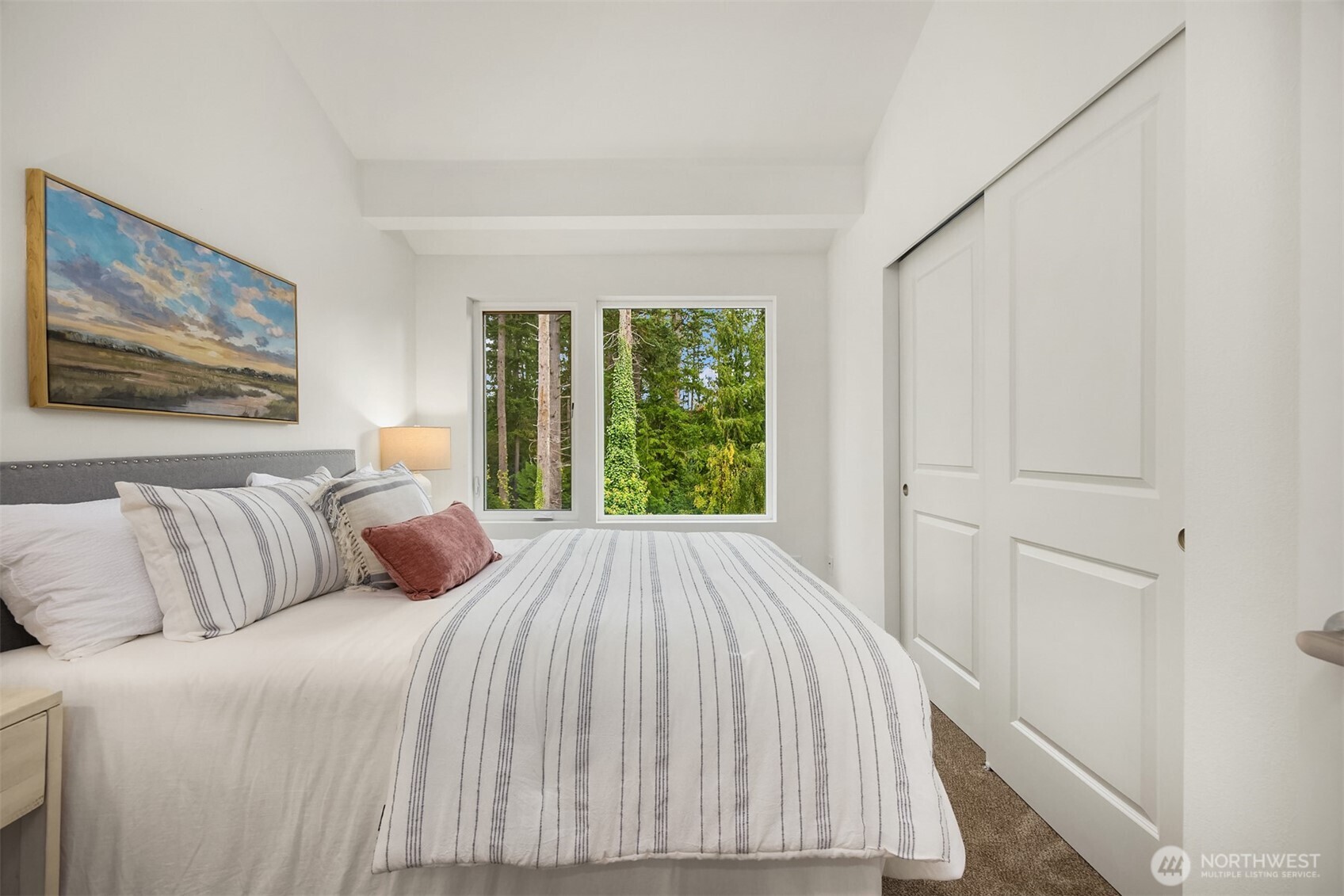 1359 Nolta Loop Northeast Bainbridge Island, WA 98110 - Photo 15 of 28 a bed sitting in a bedroom next to a window