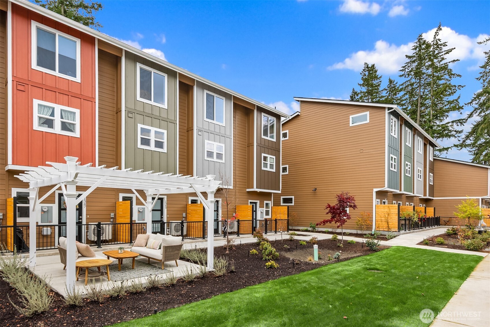 1359 Nolta Loop Northeast Bainbridge Island, WA 98110 - Photo 2 of 28 a front view of residential houses with yard and outdoor seating