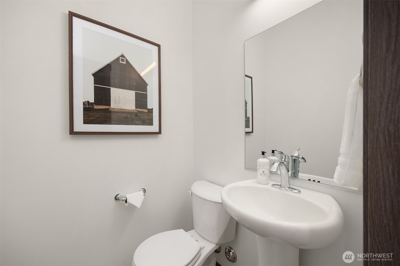 1359 Nolta Loop Northeast Bainbridge Island, WA 98110 - Photo 5 of 28 a bathroom with a toilet sink and mirror