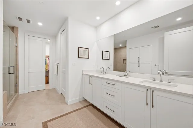 a spacious bathroom with a double vanity sink mirror and