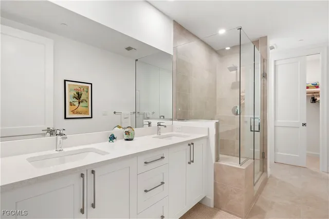 a bathroom with a double vanity sink mirror and double